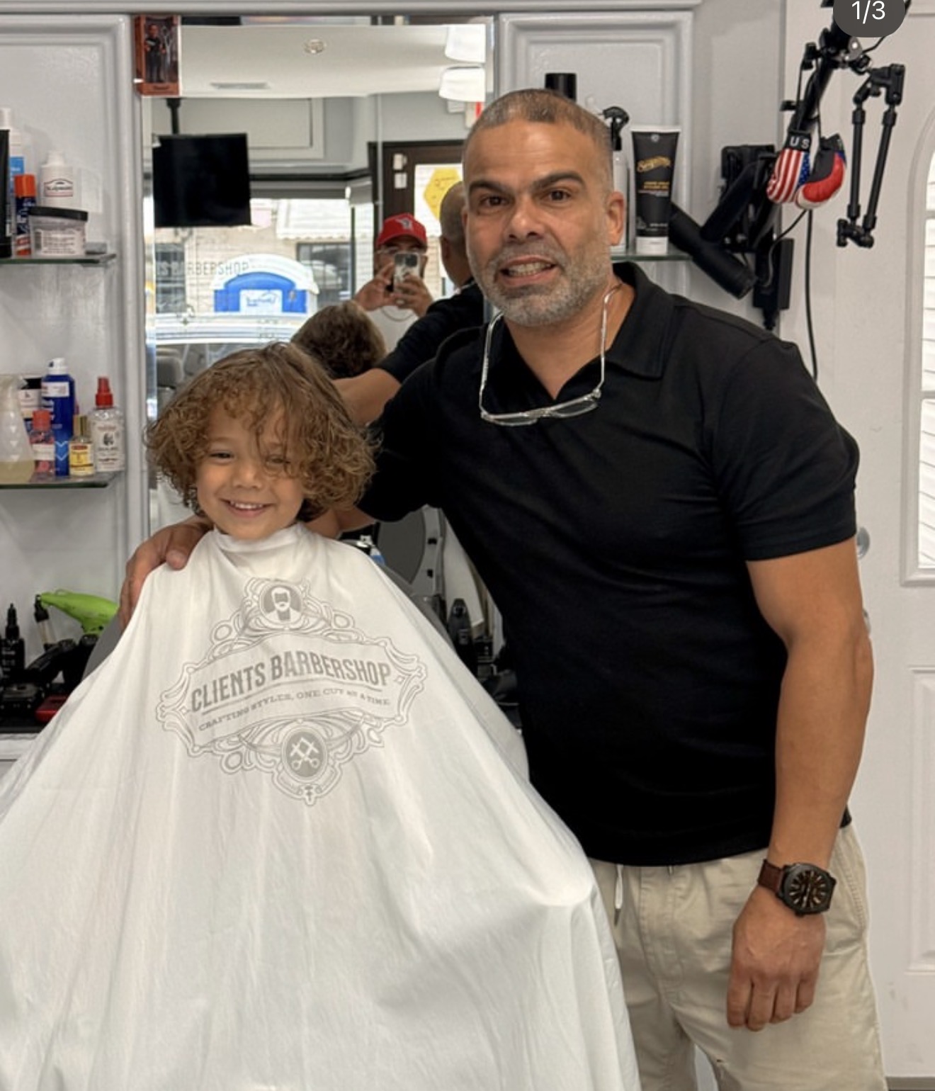 Daniel Rivera with a young client at Clients Barbershop